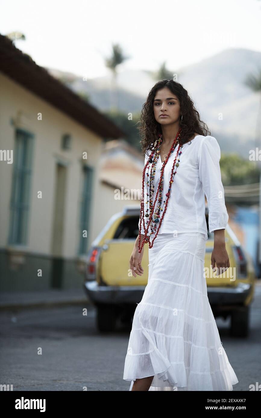Young longhaired hippy-looking woman crossing street in Choroni village ,Henri Pittier National Park,Venezuela Stock Photo