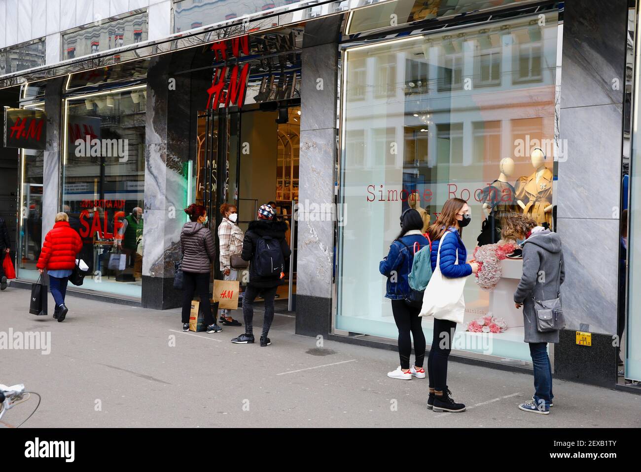 Clients wait in front of a re-opened H&M clothing store after the Swiss  government relaxed some of its COVID-19 restrictions, as the spread of the  coronavirus disease continues, at the Bahnhofstrasse shopping