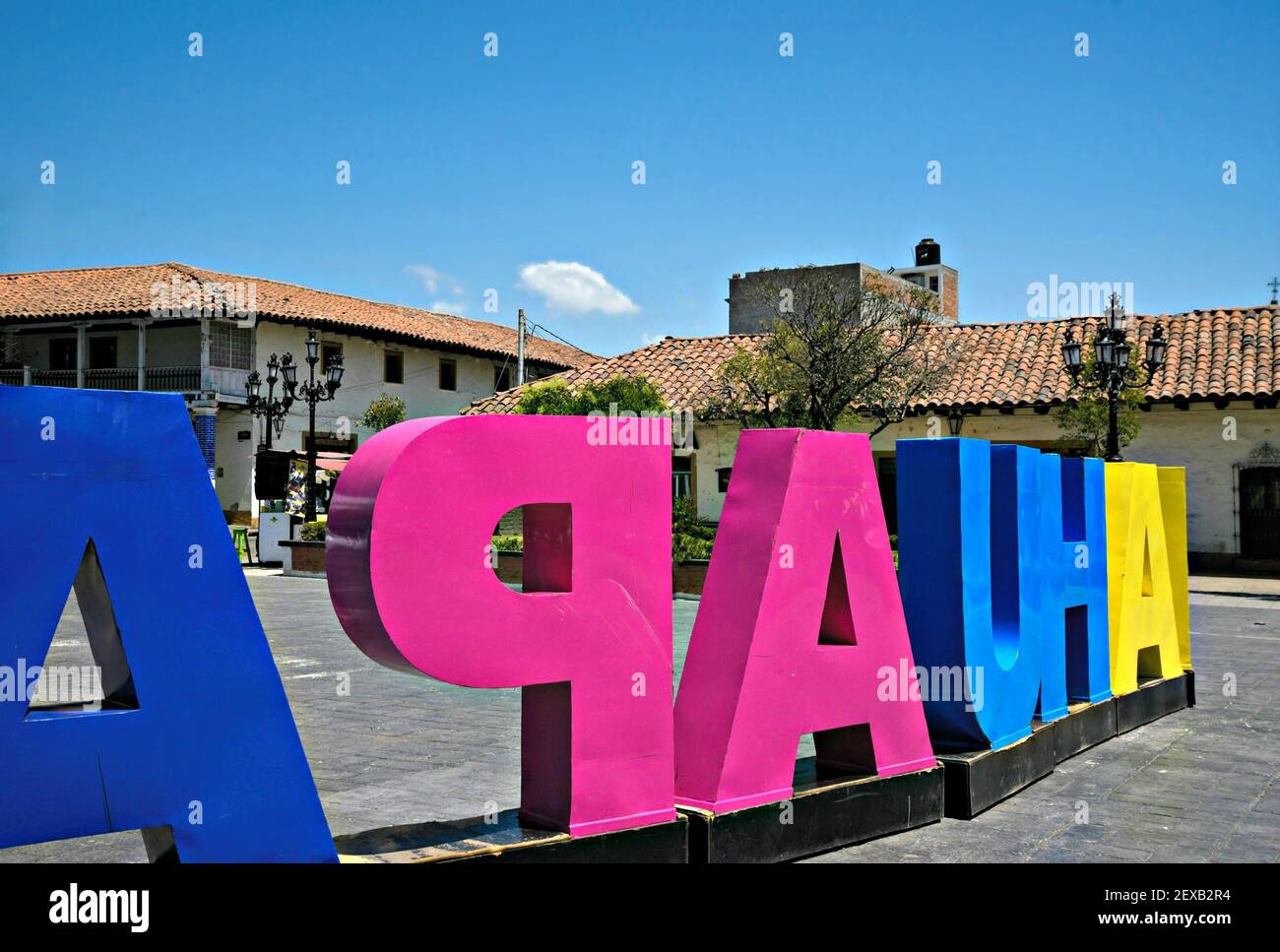 Colonial buildings with a colorful town letter sign on the foreground ...
