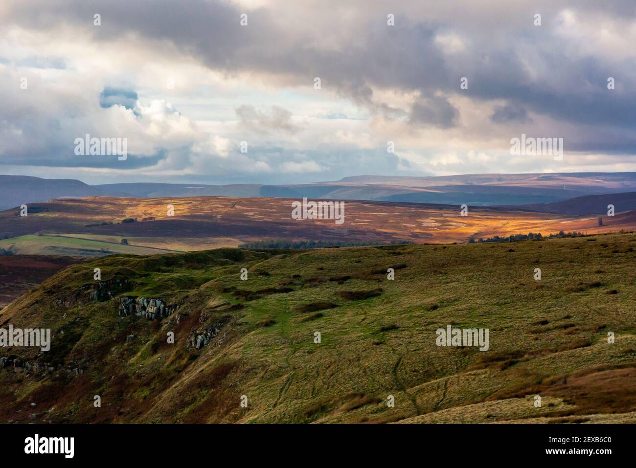View looking down on the Peak District National Park from Hathersage Moor Derbyshire England UK with stormy sky above. Stock Photo