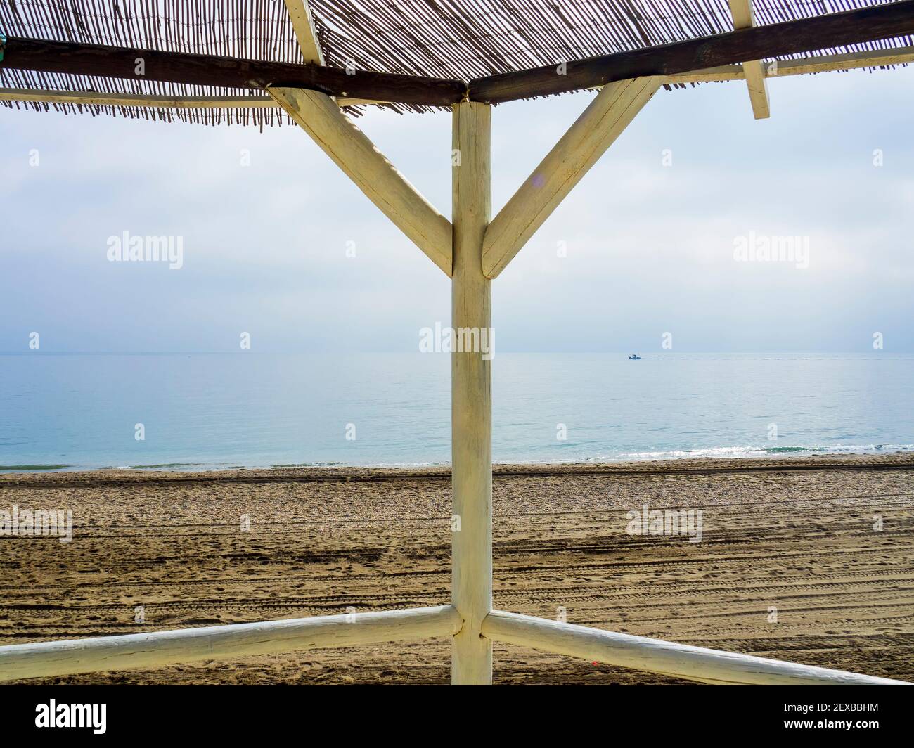 Wooden pergola of a beach bar in front of a calm sea Stock Photo