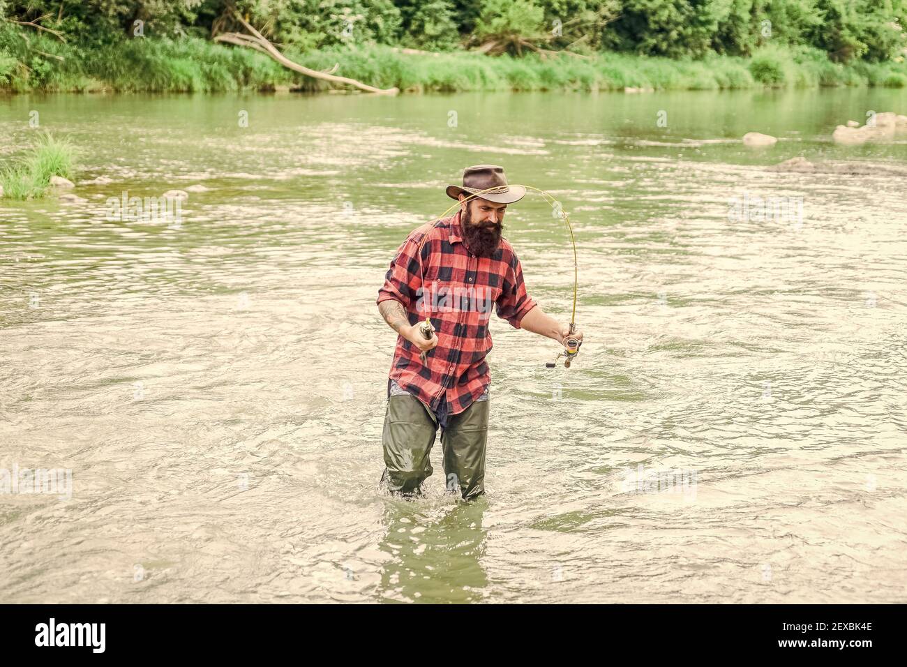 Fisherman Stands Rubber Boots Swamp River Holds Fishing Rod His — Stock  Photo © style-photo #193974830