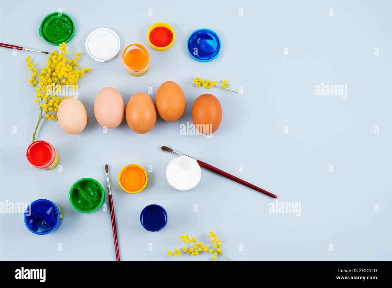 Eggs and paints. Easter eggs decoration process. Copy space. Top view. Stock Photo