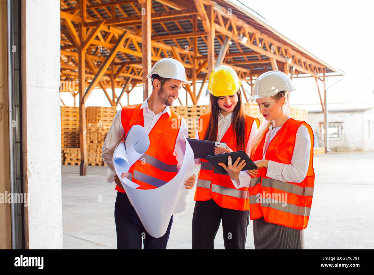 Team of young architects using tablet and blueprints Stock Photo