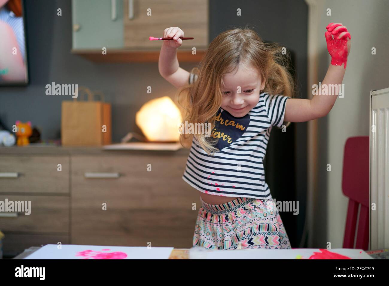 Happy smilling cute little girl with raised hands Stock Photo - Alamy