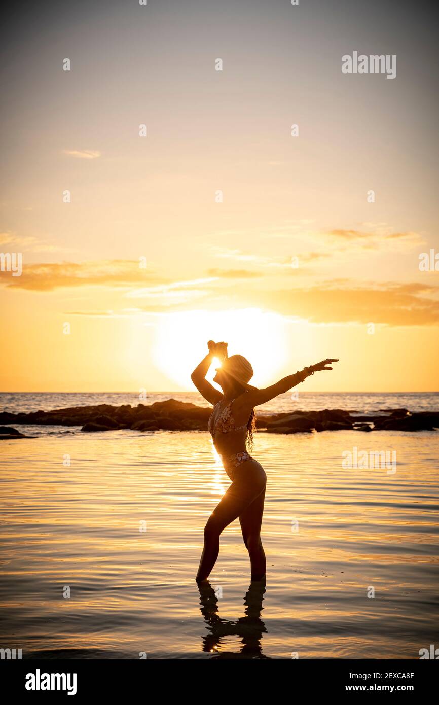 A Woman in Purple Swimsuit Posing at the Beach during Sunset · Free Stock  Photo