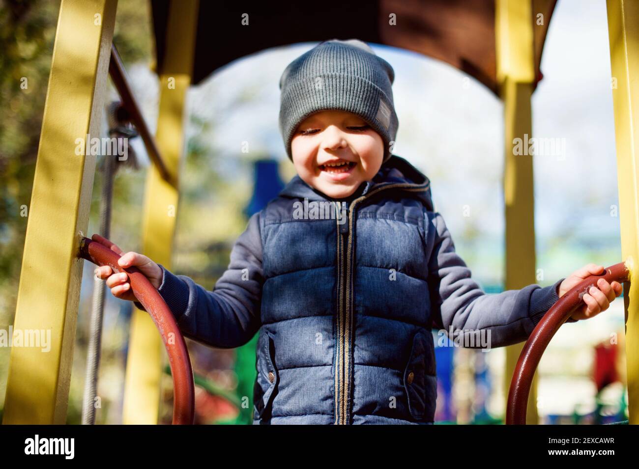 Laughing happy kid at playground, autumn outdoors activity Stock Photo