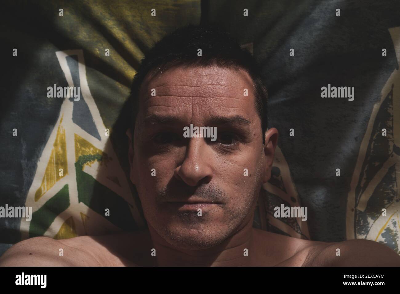 man in bed waking up in the morning, lazy days Stock Photo