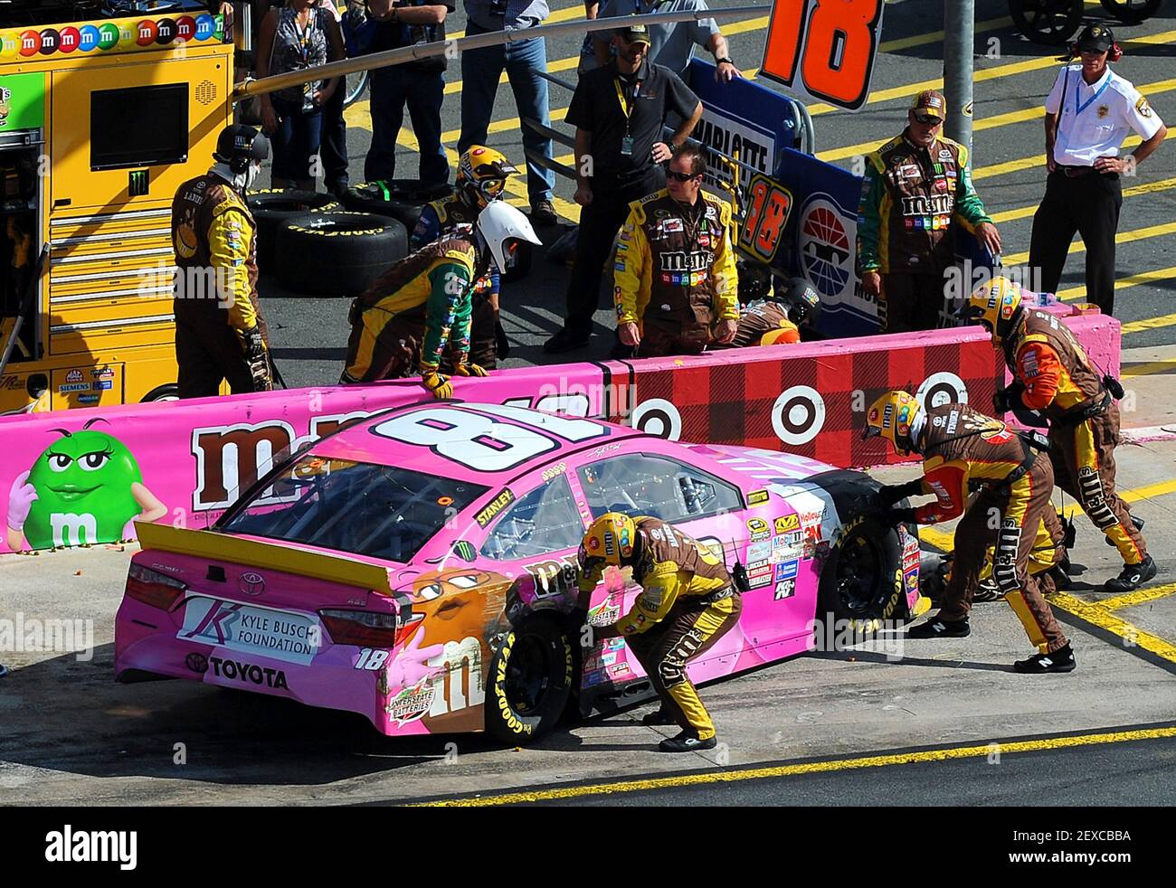 NASCAR Sprint Cup Series driver Kyle Busch's pit crew work to make repairs  to the car after he was involved in an accident with driver Kyle Larson  entering pit road during the