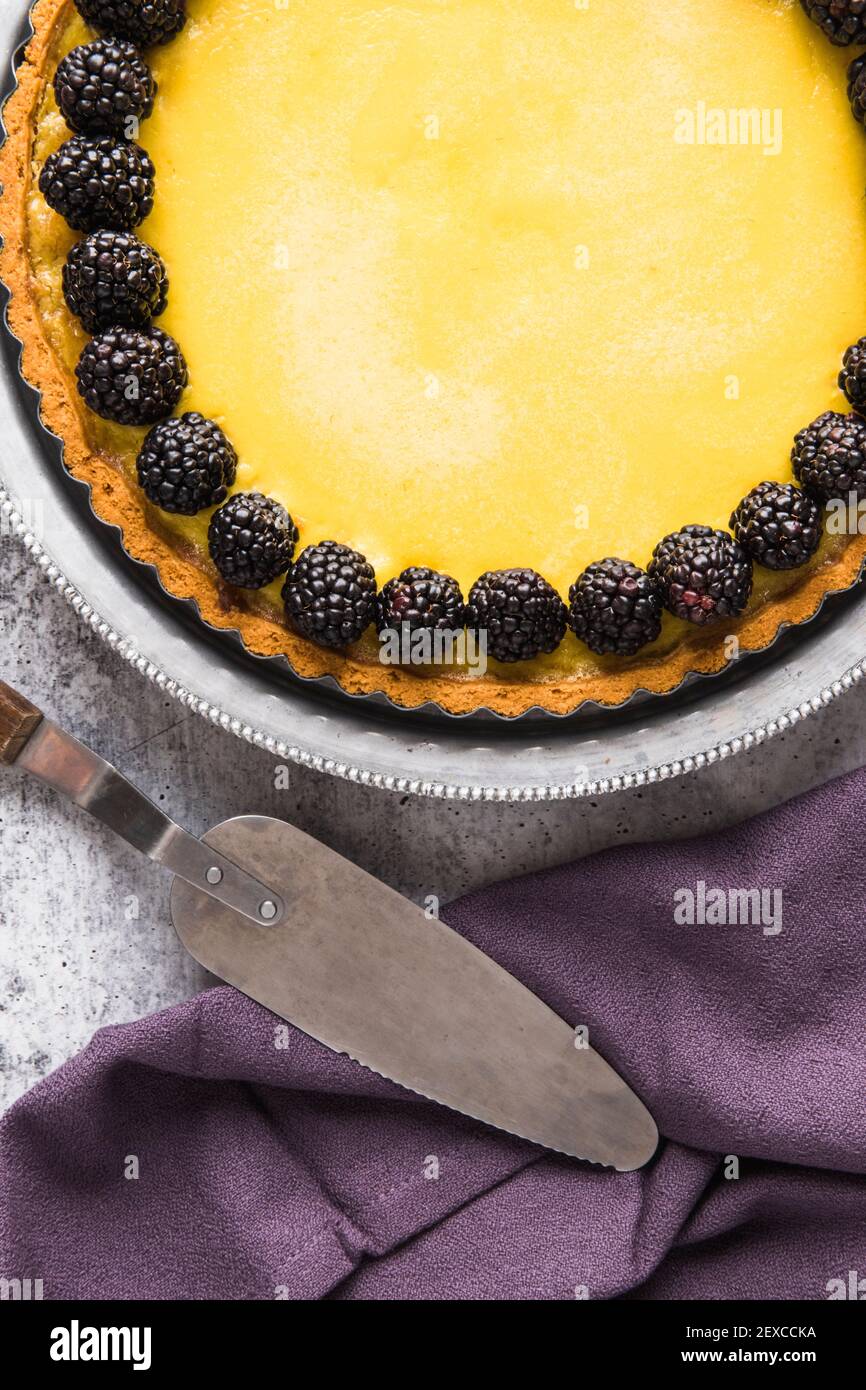 Food Flatlay of Lemon Custard Tart with Blackberry Stock Photo