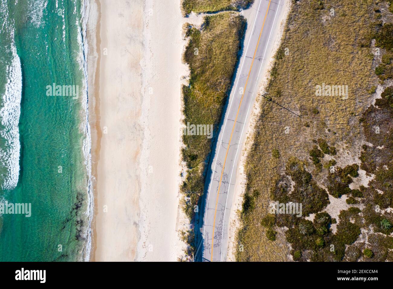 Beach Road and Ocean on a Sandy Beach Shoreline from Aerial Drone Stock Photo