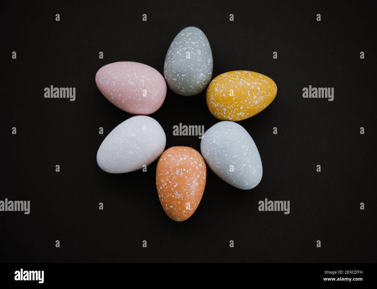 High angle overhead view of colored Easter eggs on black background Stock Photo