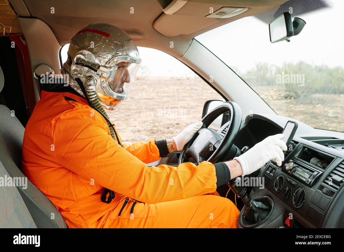 Man dressed as an astronaut using GPS Stock Photo