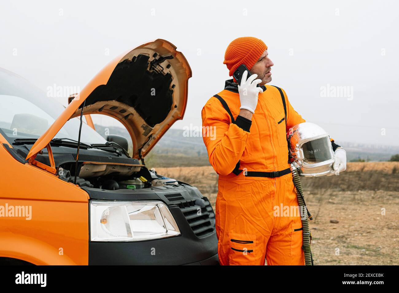 Man dressed as astronaut using smart phone Stock Photo