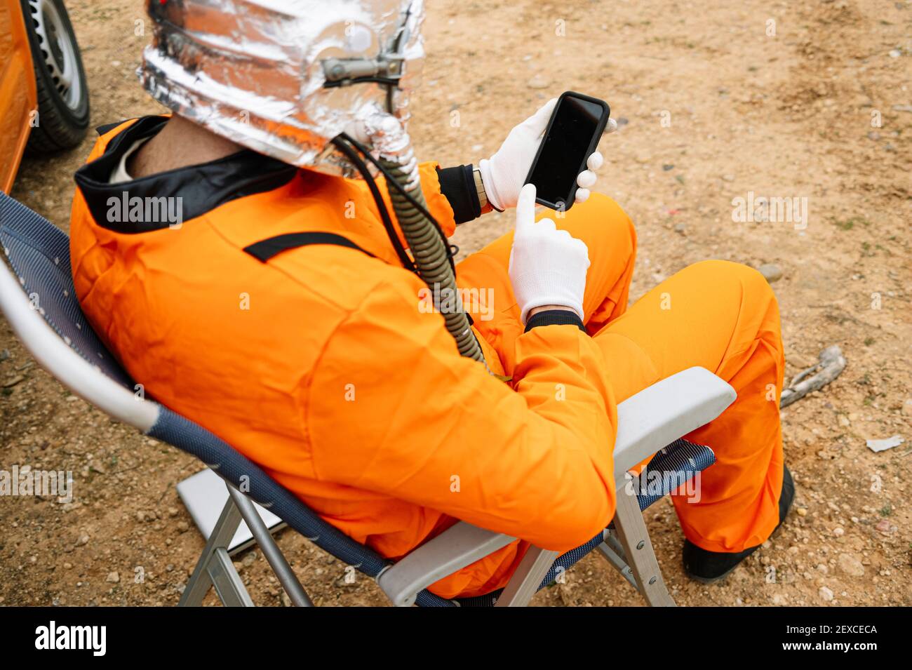 Man dressed as astronaut using smart phone Stock Photo