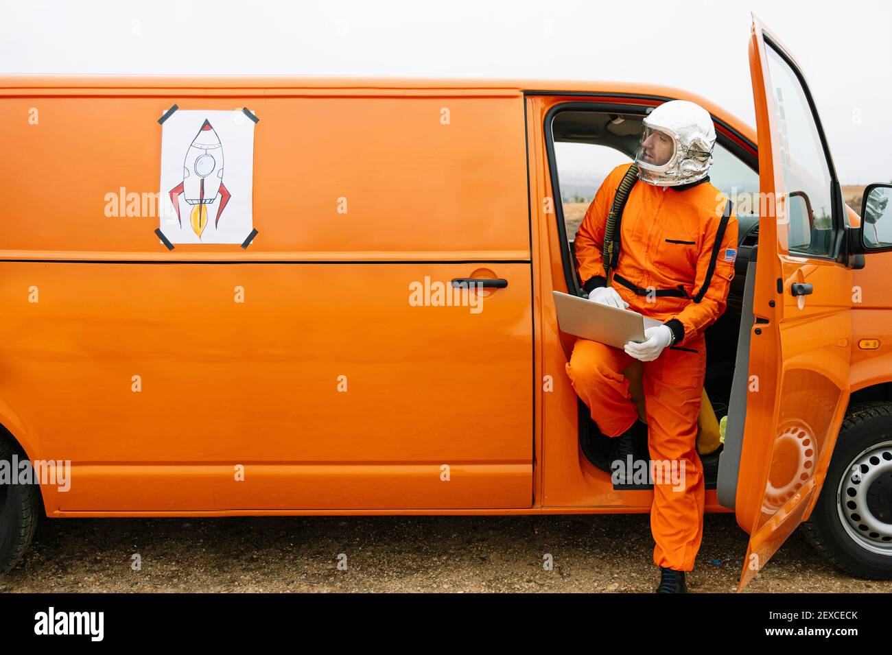 Man dressed as astronaut using laptop Stock Photo