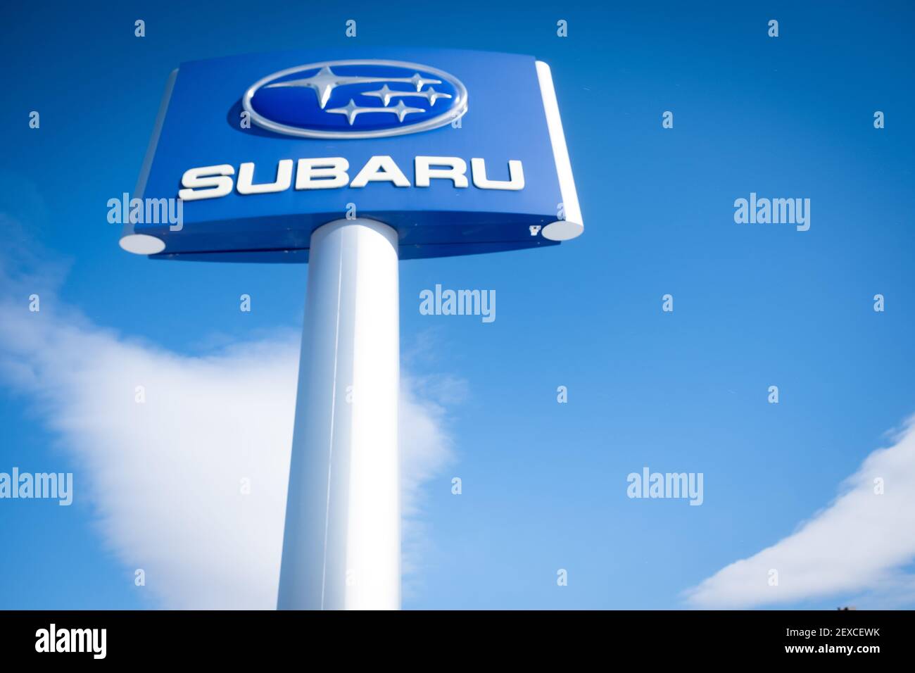 Beautiful bright dramatic photo of Subaru corporate logo against bright blue sky, Twin City Subaru, Berlin, VT, USA. Stock Photo