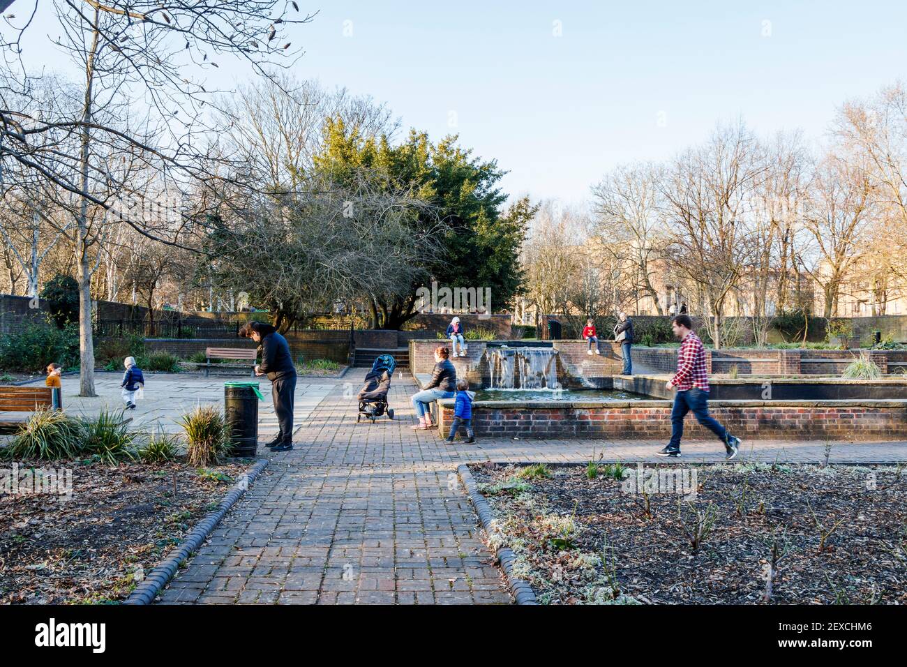 Parents and children in the Peace Garden of Elthorne Park on a winter afternoon during the third coronavirus lockdown, Islington, London, UK Stock Photo