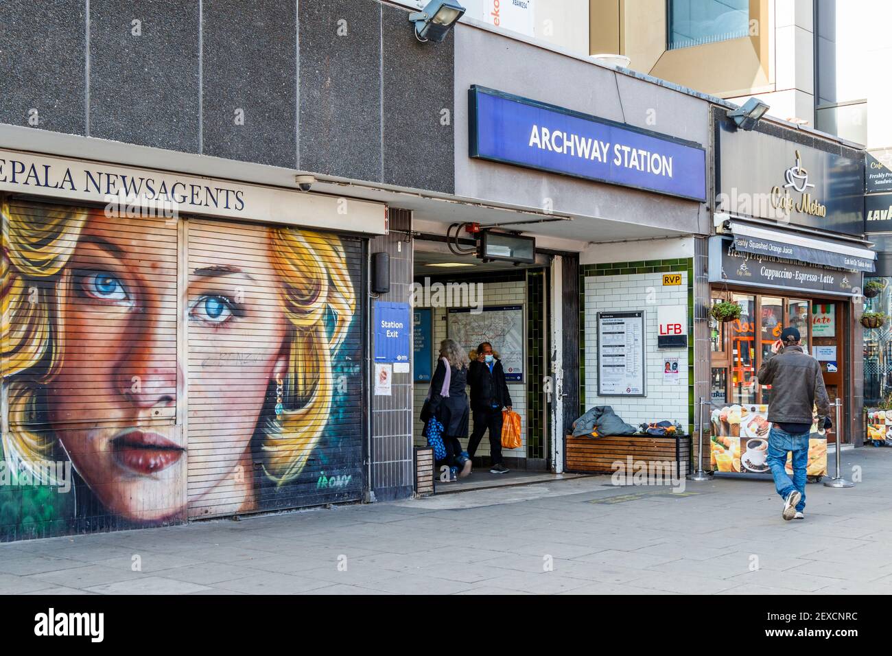 Mural of a woman's face on the shutters of a closed newsagent next to Archway tube during the third coronavirus lockdown, Islington, London, UK Stock Photo