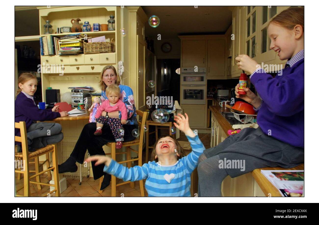 Joanna Moorehead with daughters Rosie 11,Elinor 8, Miranda 4 and Catrina 1 at home in south west London.pic David Sandison 3/4/2003 Stock Photo