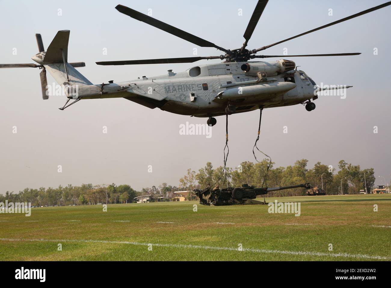 A U.S. Marine Corps CH-53E Super Stallion helicopter with Marine Heavy Helicopter Squadron 463, Marine Rotational Force – Darwin, releases the straps after an external lift of an M777A2 lightweight 155 mm howitzer Aug. 5, at Robertson Barracks, Palmerston, Northern Territory. The Marine pilots and aircrew, along with soldiers with 8th/ 12th Regiment, Royal Australian Artillery, 1st Brigade, Australian Army, Australian Defence Force, planned and conducted the external lift of the howitzer and familiarized both units with each other’s training procedures to enhance interoperability. The MRF- Stock Photo