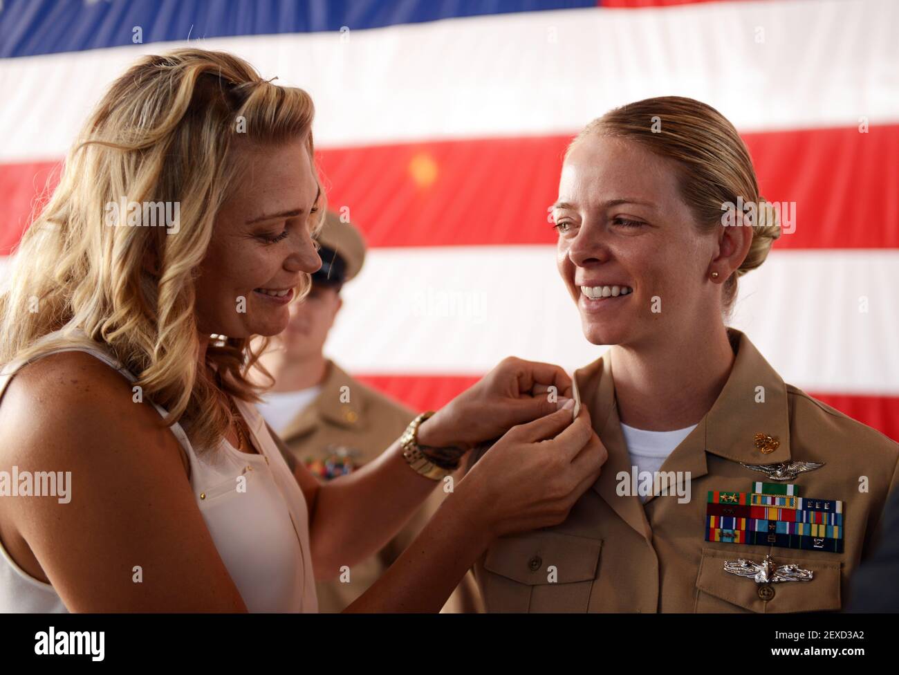 SAN DIEGO (Sept. 16, 2015) Chief Aviation Ordnanceman Misty Beck is pinned by her wife during a chief petty officer pinning ceremony at Naval Air Station North Island. Beck and 20 other chief selectees from six different commands were pinned during the ceremony in the hangar of Fleet Logistics Support Squadron (VRC) 30. (Photo by Mass Communication Specialist 2nd Class Stephanie Smith/U.S. Navy) 150916-N-MH885-102 *** Please Use Credit from Credit Field *** Stock Photo