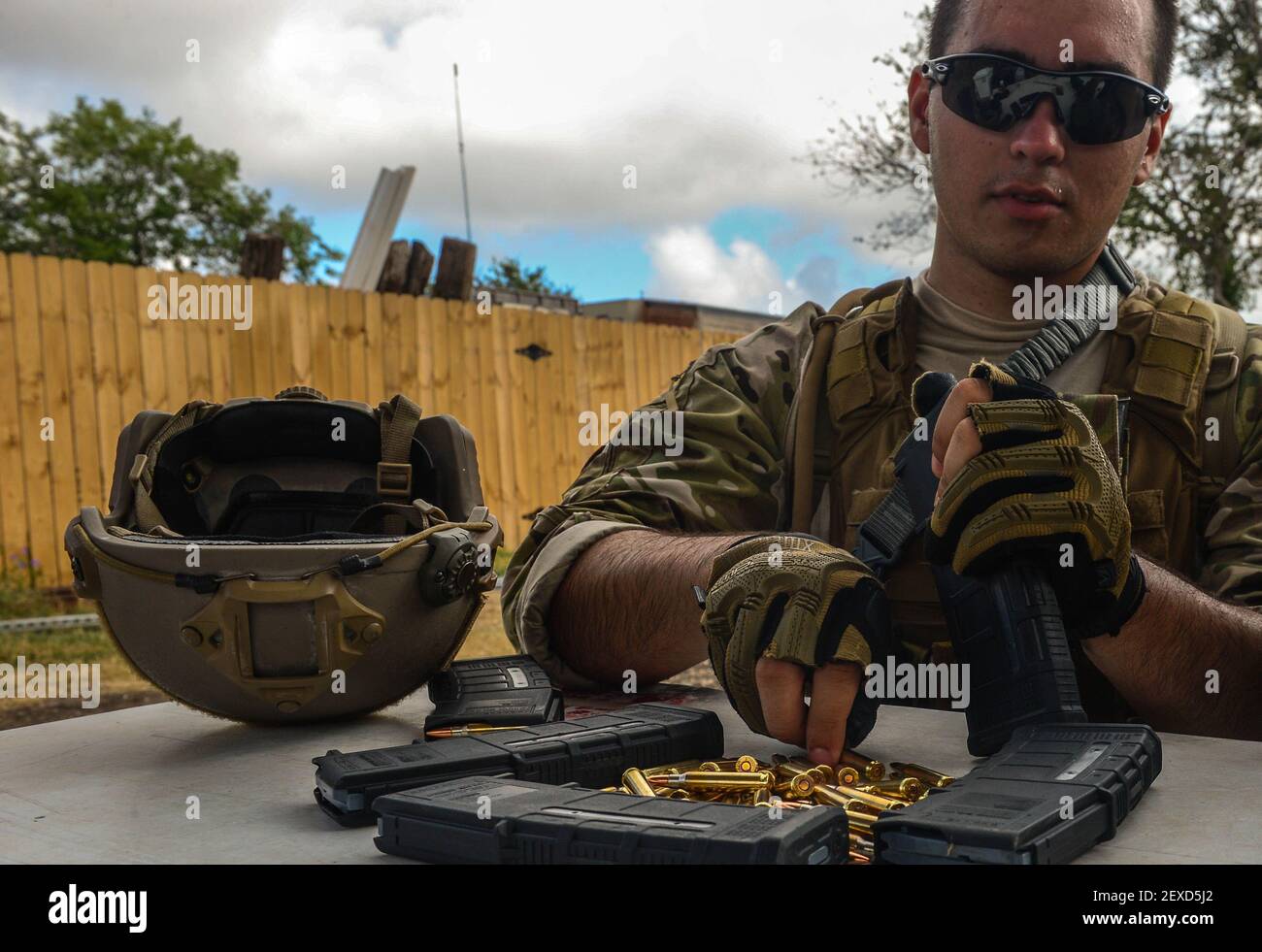 Airman 1st Class Stefan Alvarez, a 3rd Combat Camera Squadron photojournalist, loads 5.56 mm ammunition into an M4 magazine in preparation for the next drill during Advanced Weapons and Tactics Training Sept. 4, 2015, in Converse, Texas. The two-week course taught combat camera Airmen shooting fundamentals, weapon transitioning, shooting on the move and engaging threats in low-light conditions. (Photo by Senior Airman Colville McFee/U.S. Air Force) *** Please Use Credit from Credit Field *** Stock Photo