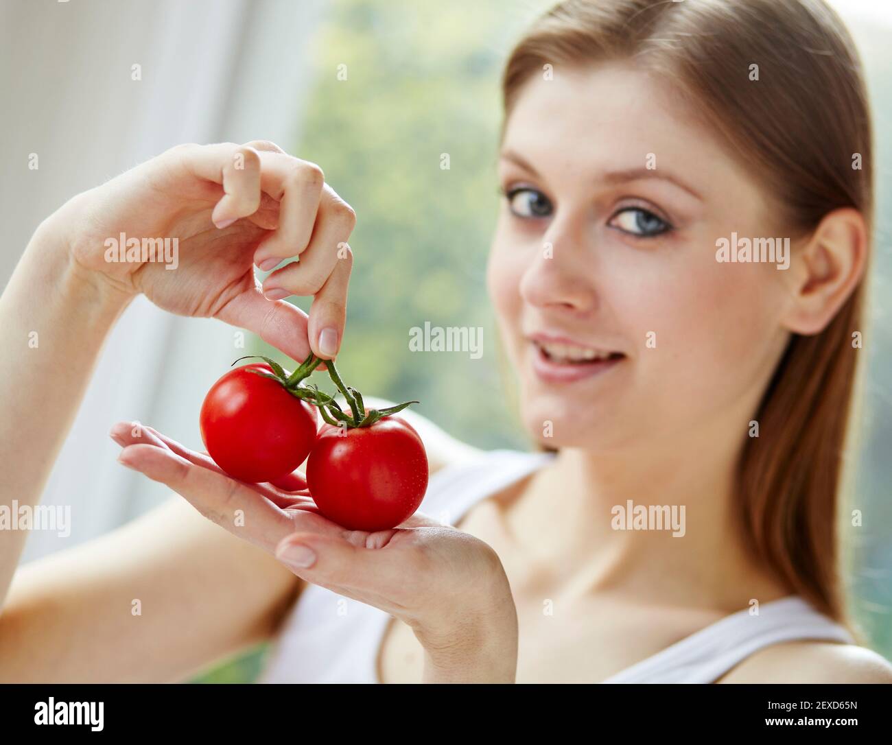 Woman holding a bunch of tomatoes Stock Photo