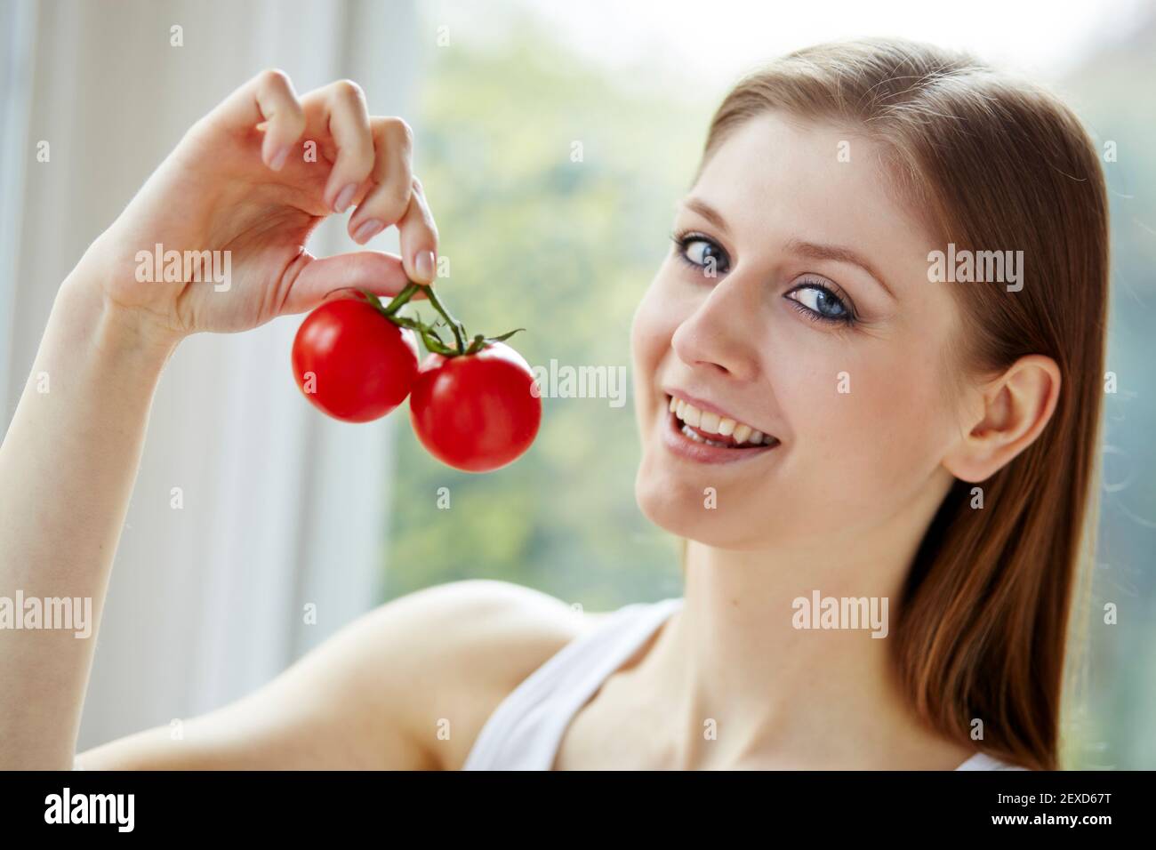 Woman holding a bunch of tomatoes Stock Photo