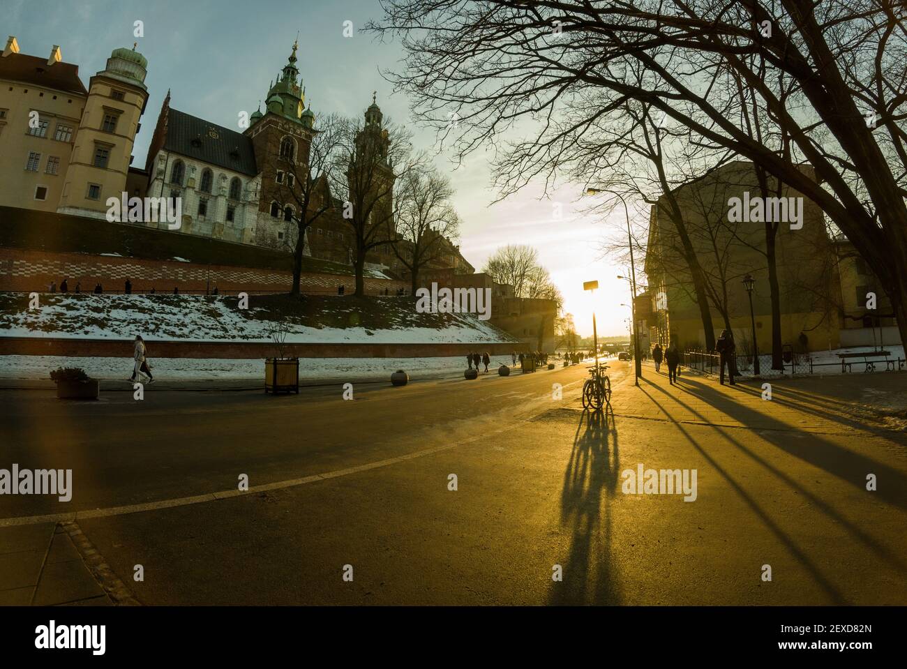 Krakow, Poland - February 22, 2021: Road to the main entrance to royal Wawel Castle in Cracow and bicycle parked against sunset Stock Photo