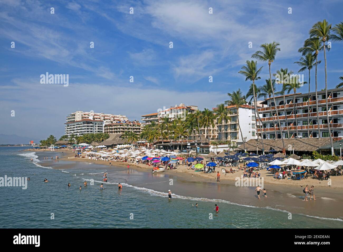Sunbathers and hotels at Puerto Vallarta, Mexican beach resort city situated on the Pacific Ocean's Bahía de Banderas, Jalisco, Mexico Stock Photo