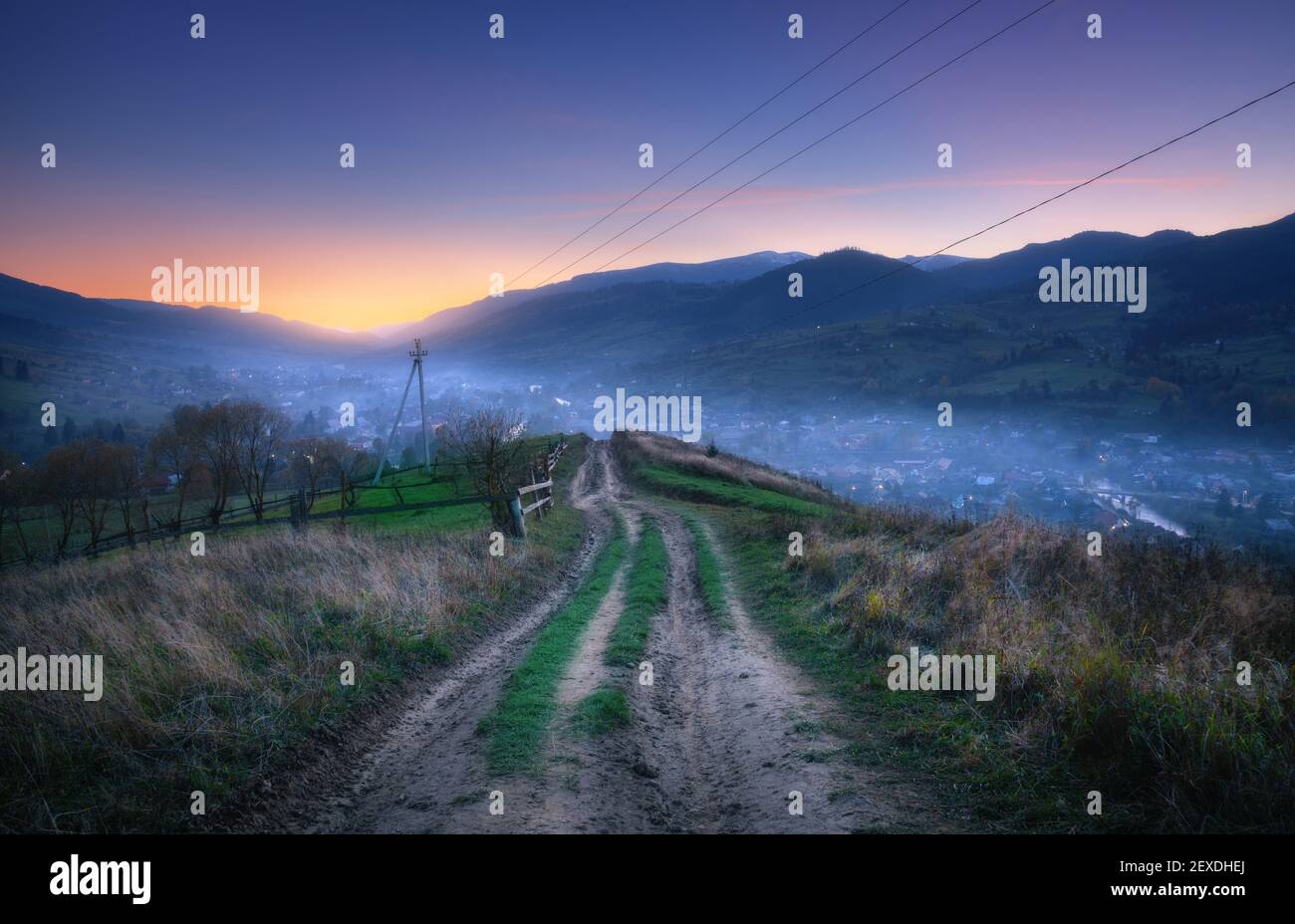 Mountain dirt road at beautiful sunset in summer Stock Photo