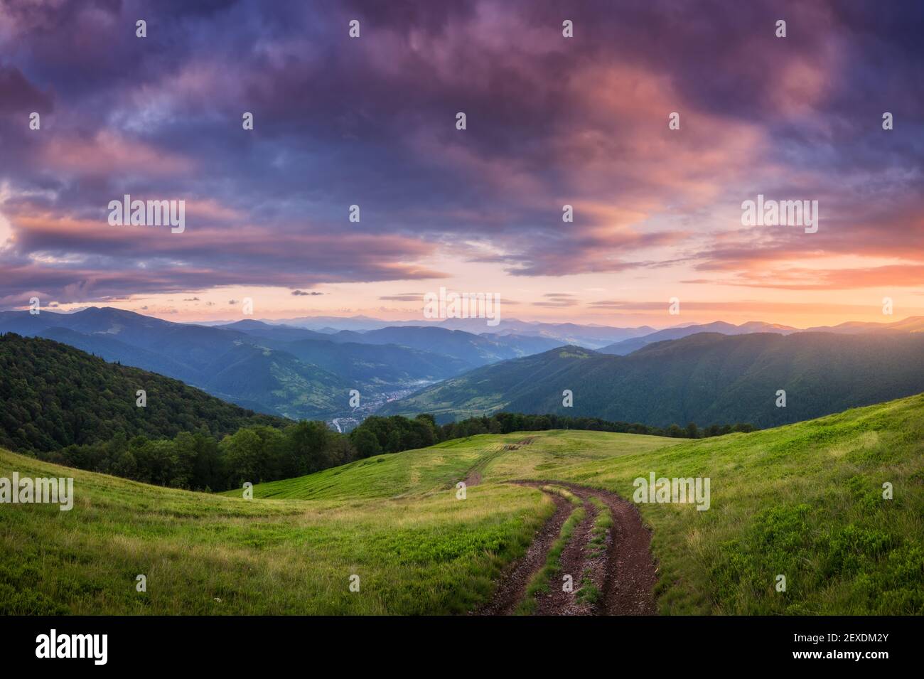 Mountain dirt road at beautiful sunset in summer Stock Photo