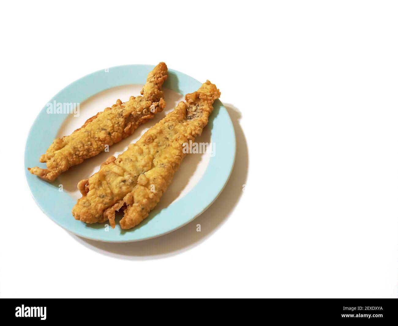 High angle shot of fresh tasty fried battered hake fish filet on a plate  isolated on a white background Stock Photo - Alamy