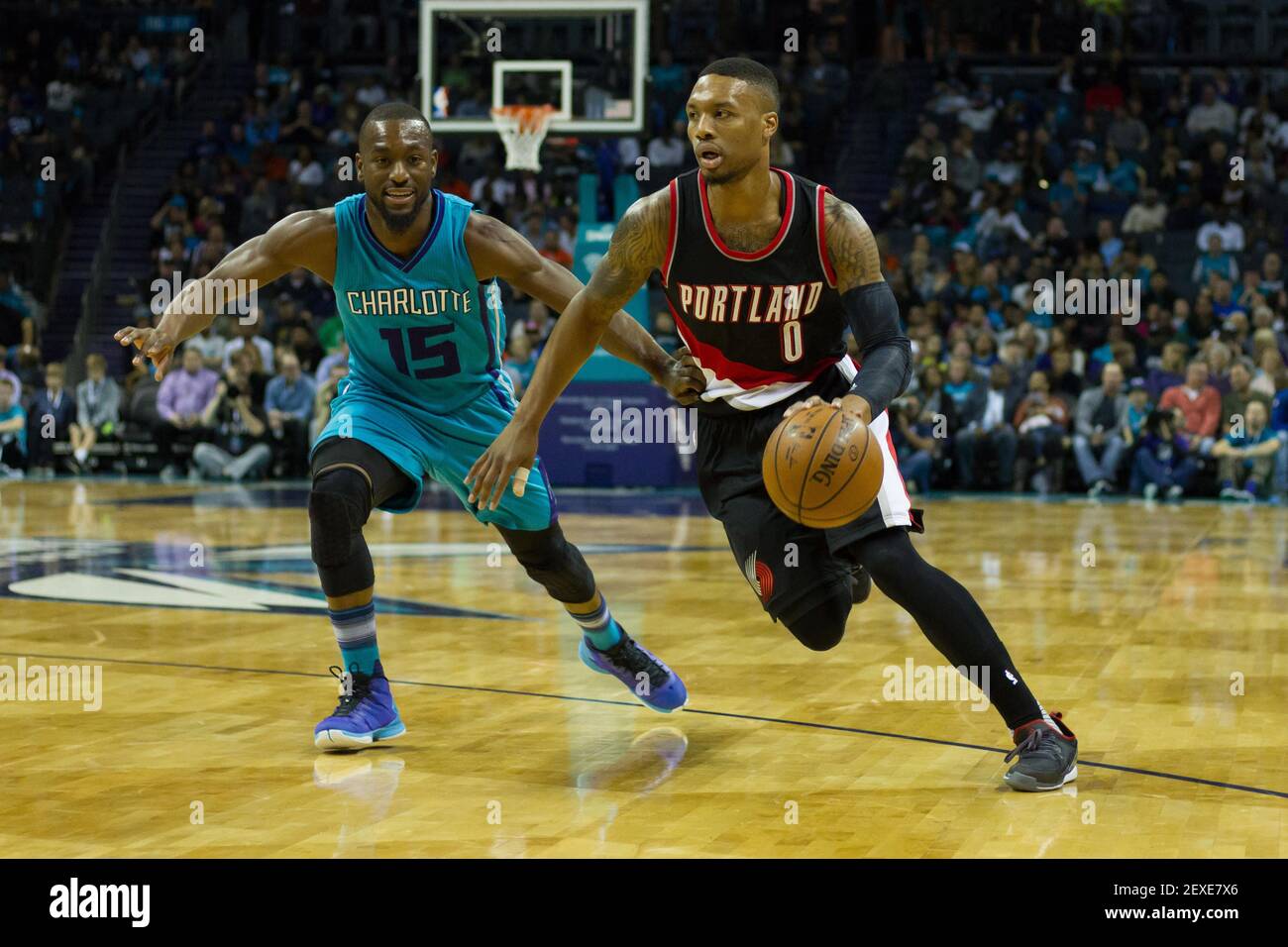 Nov 15, 2015; Charlotte, NC, USA; Portland Trail Blazers guard Damian  Lillard (0) drives the ball while Charlotte Hornets guard Kemba Walker (15)  defends during the first half at Time Warner Cable