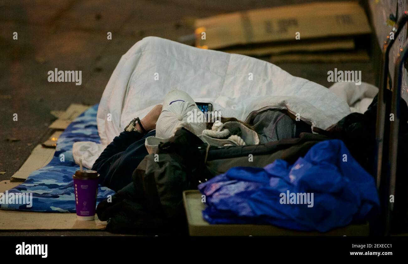 ***FILE***A man lies on the streets of New York City. Amid the ...