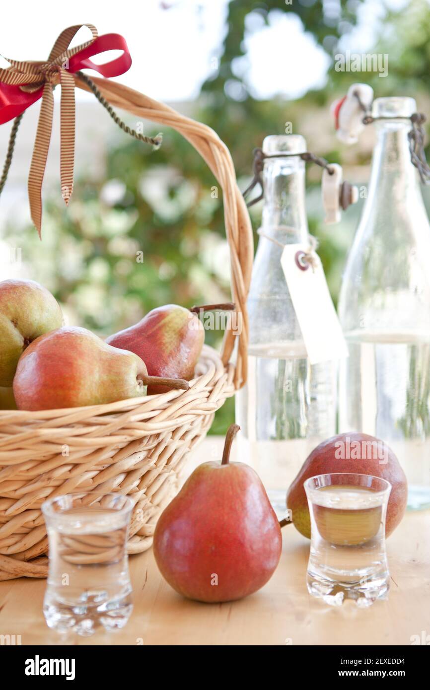 Self-distilled clear schnapps and pears Stock Photo