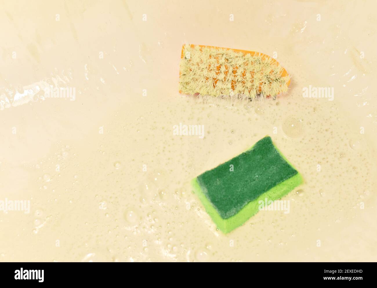 Sponge with washing brus and detergent during cleaning bathroom or