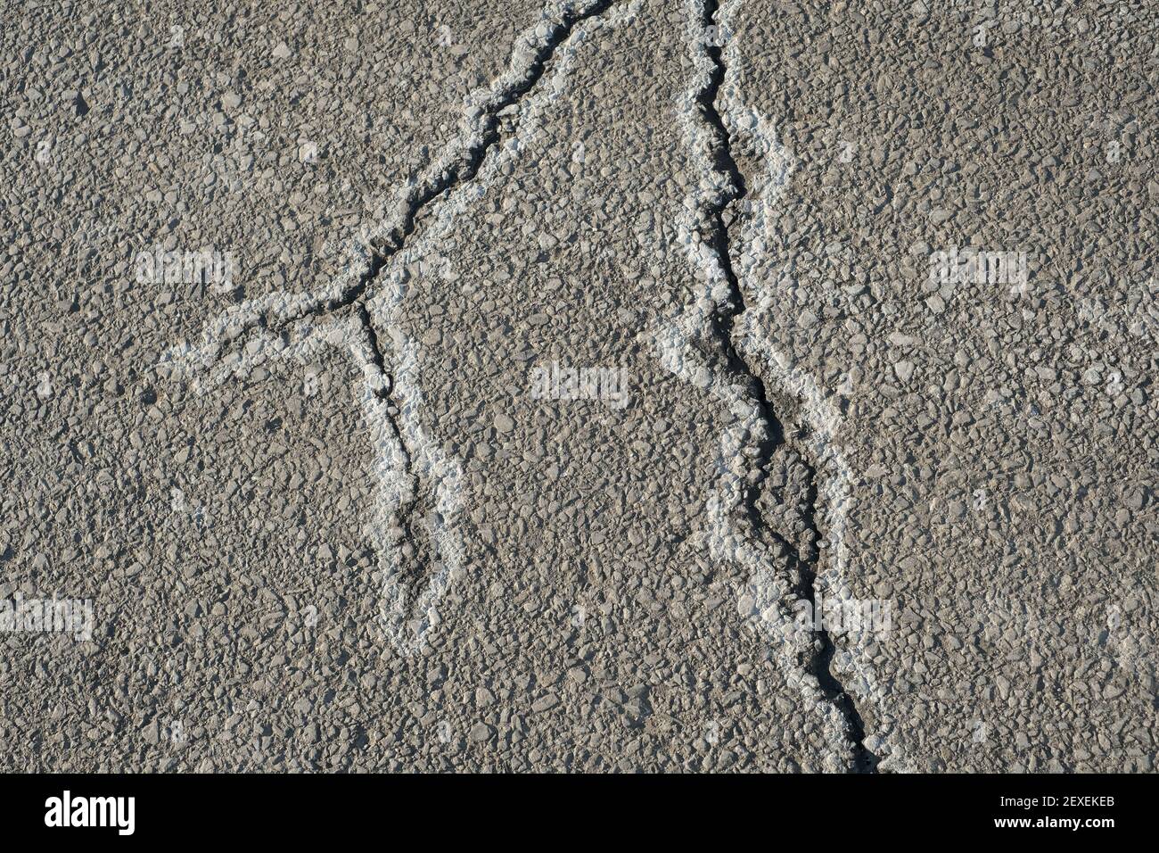 Cracks in asphalt pavement are lined with the residue from road salt