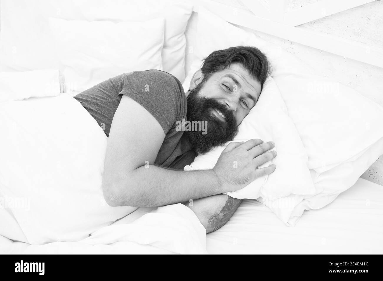 Just relaxing. bachelor feel comfortable. guy at bedroom. lazy sunday. bed time routine. smiling male spending time in room. relax lifestyle. happy bearded man in bed. wake up at morning. Stock Photo