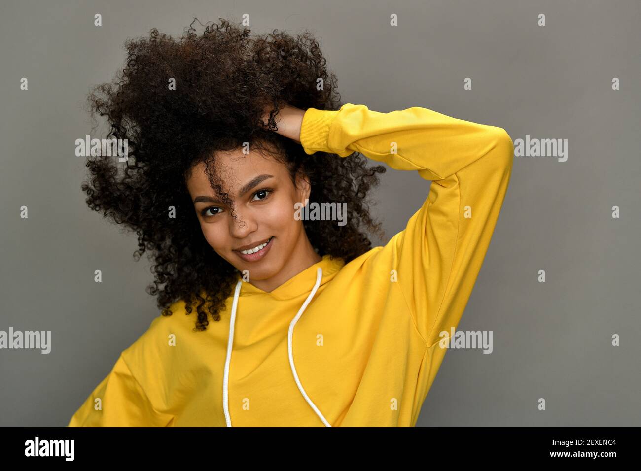 A beautiful young african american woman smiling, with tousled afro hair. Stock Photo