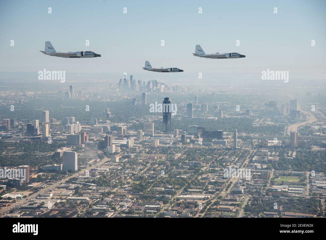 NASA's three WB-57s fly over foggy downtown Houston, Texas during their  historic formation flight over the area on Nov. 19, 2015. This photo flight  was the first time that all three WB-57s