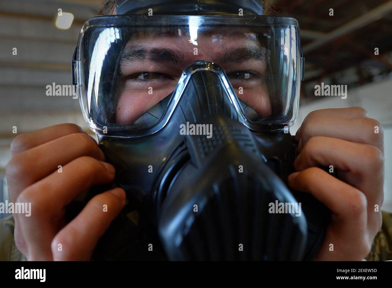 Airman 1st Class Kyle Denzine, a 20th Operations Support Squadron aircrew flight equipment specialist, checks the seal of his gas mask at Shaw Air Force Base, S.C., Oct. 23, 2015. Denzine, along with other AFE Airmen, practiced the actions they would take in the event a pilot needs to be decontaminated upon his return to base. (Photo by Senior Airman Michael Cossaboom/U.S. Air Force) *** Please Use Credit from Credit Field *** Stock Photo