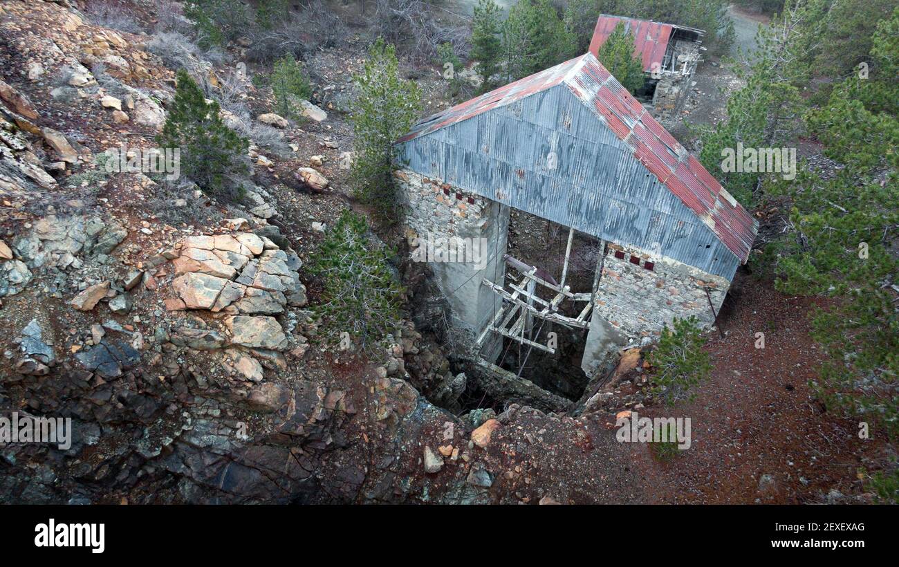Old broken lift over vertical shaft of abandoned chromite mine, aerial view Stock Photo