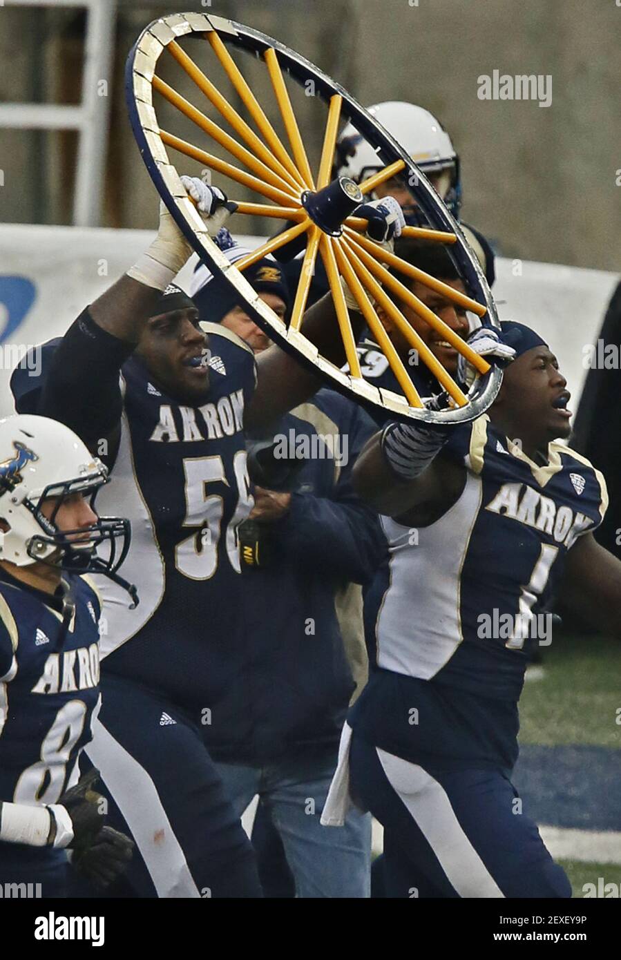 University of Akron football players Isaiah Williams, left, and Jatavis  Brown celebrate as the carry the Wagon Wheel trophy over to their fans in  the stands after the Zips' 20-0 victory against
