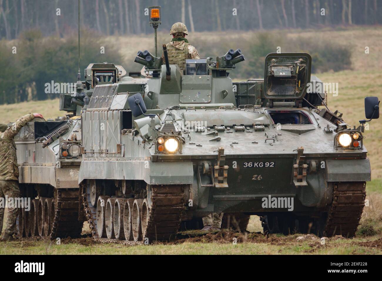 british army FV512 warrior MRV preparing to tow a stricken warrior FV510 light infantry fighting vehicle tank on Salisbury Plain, Wiltshire Stock Photo