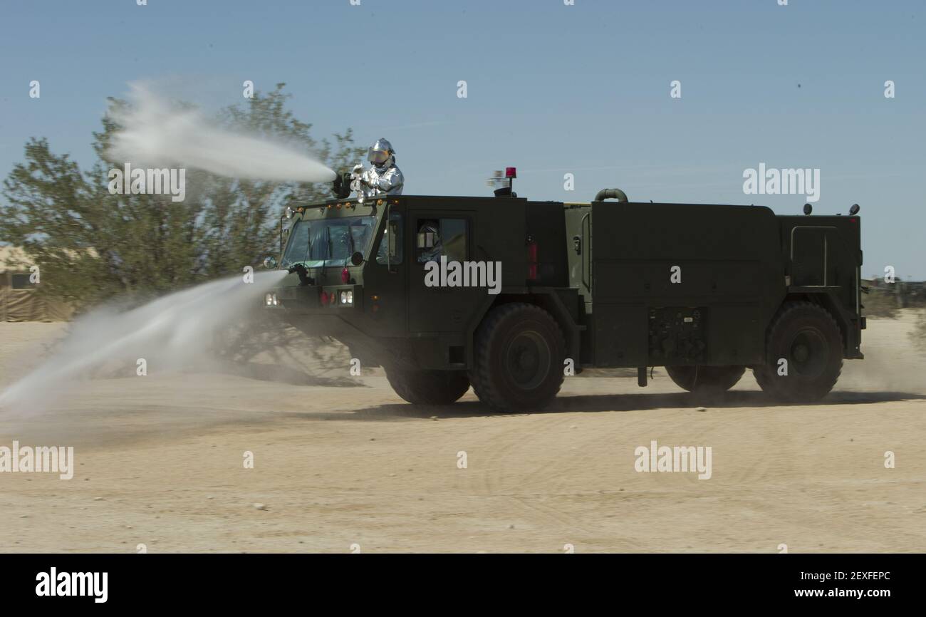U.S. Marines with Marine Wing Support Squadron 374, Aircraft Rescue and Firefighting, demonstrate a handline drill to the Air Ground Support students at Weapons and Tactics Instructor (WTI) Course 1-16 training area on Sept. 19, 2015, Yuma, Ariz. This familiarization tour is apart of WTI 1-16, a seven week training event, hosted by Marine Aviation Weapons and Tactics Squadron One (MAWTS-1) cadre, which emphasizes operational integration of the six functions of Marine Corps aviation in support of a Marine Air Ground Task Force. MAWTS-1 provides standardized advanced tactical training and certif Stock Photo