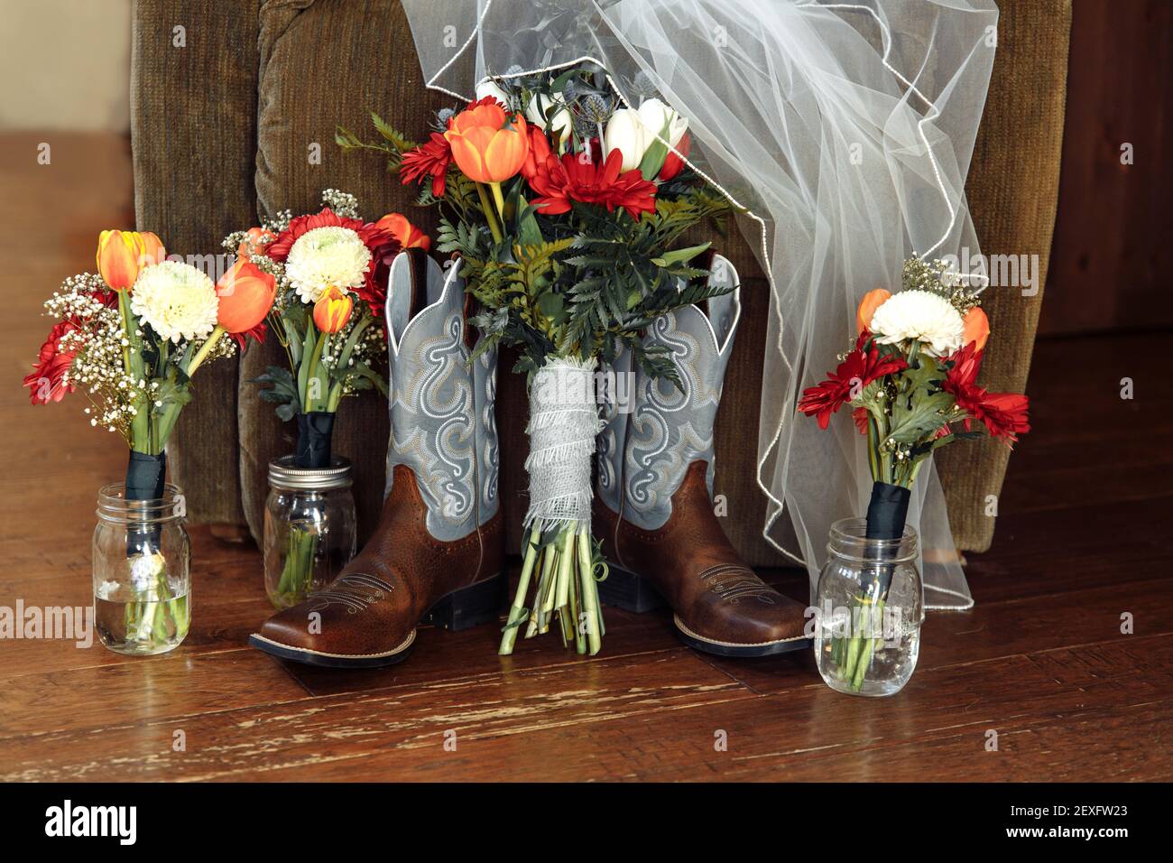 Winter wedding bouquet red chrysanthemum, orange tulips, blue thistle and fern leaves