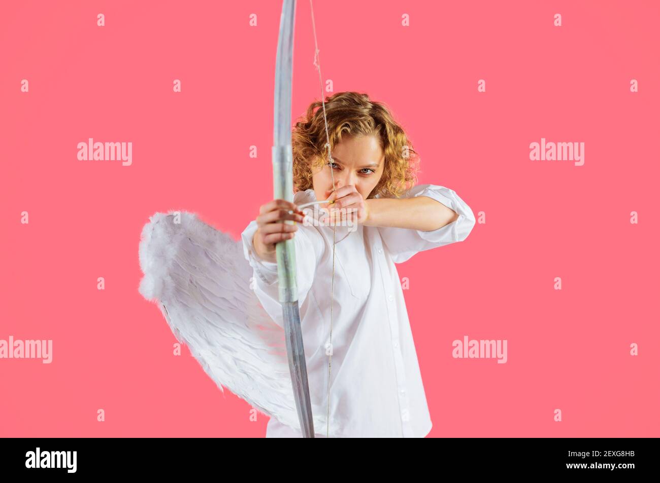 Valentines Day. Angel girl with arrows and bow. Cupid woman with white wings. Stock Photo