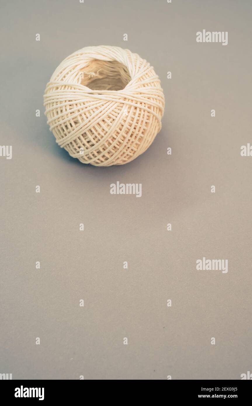 A vertical shot ofwhite ball of twine isolated on a grey background Stock Photo